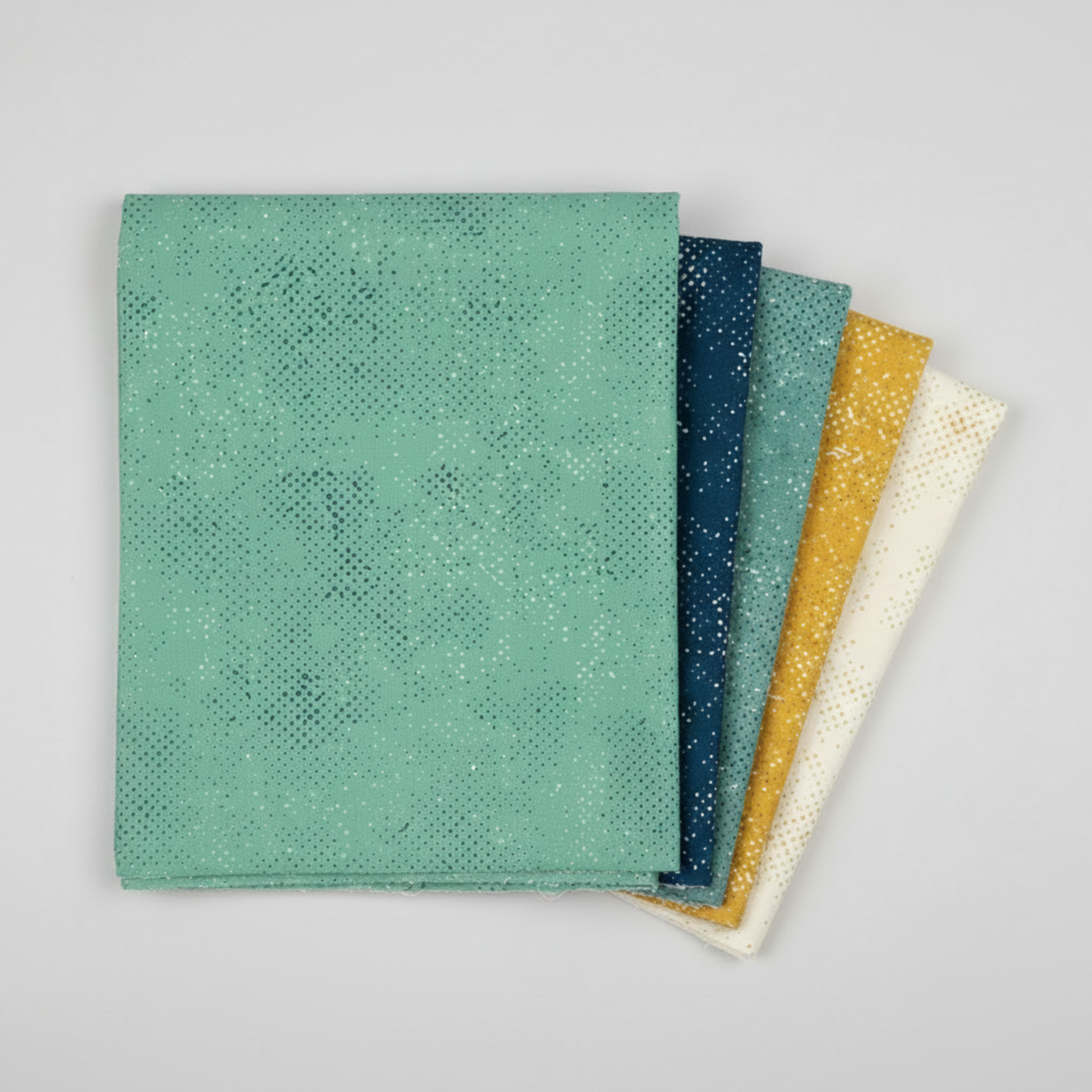 Spotted Chill-Aqua fabric by Zen Chic for Moda Fabrics shown in a coordinating fabric fan with Spotted Mood Dark Blue, Spotted Dusty Teal, Spotted Sunny, and Spotted Ivory — all available at IraRobi Quilts.