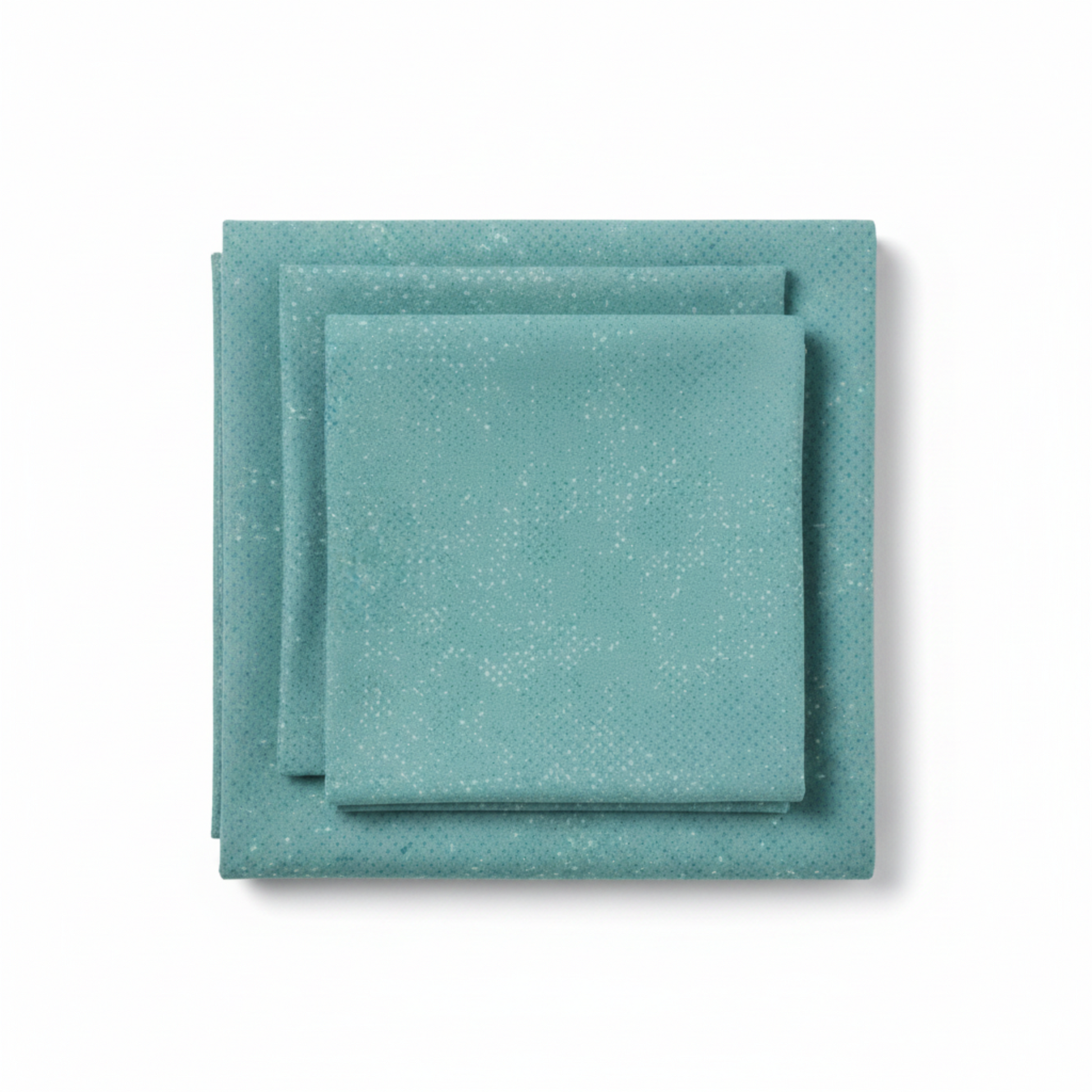 Spotted Dusty Teal quilting cotton fabric by Zen Chic for Moda Fabrics folded into a neat stack showing medium teal-blue with cool aqua undertones and subtle tonal speckled texture – a versatile near-solid blender, 100% cotton, 43–44" wide