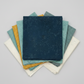 Spotted Mood Dark Blue fabric by Zen Chic for Moda Fabrics shown in a coordinating fabric fan with Spotted Chill-Aqua, Spotted Dusty Teal, Spotted Sunny, and Spotted Ivory — all available at IraRobi Quilts.
