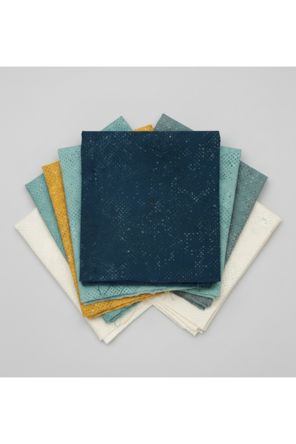 Spotted Mood Dark Blue fabric by Zen Chic for Moda Fabrics shown in a coordinating fabric fan with Spotted Chill-Aqua, Spotted Dusty Teal, Spotted Sunny, and Spotted Ivory — all available at IraRobi Quilts.