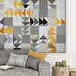 Modern flying geese quilt in cool grey, charcoal, gold and orange Interwoven geometric fabric hung above a grey sofa in a Scandinavian living room – Spotted Geese quilt pattern by Zen Chic made with Interwoven Slate background fabric by Jason Yenter. Shop Interwoven Slate at IraRobi Quilts | #flyinggeese #modernquilt #zenchic #interwovenfabric #quiltingcotton