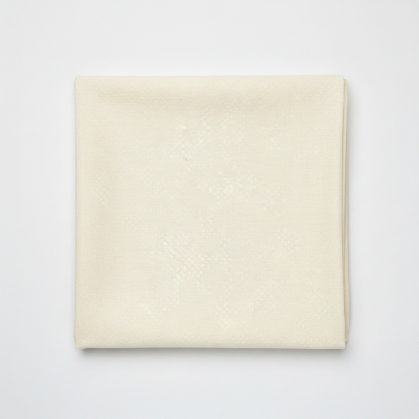 Spotted Ivory quilting cotton fabric folded to show texture – soft warm ivory tonal speckled near-solid by Zen Chic for Moda Fabrics, 100% cotton