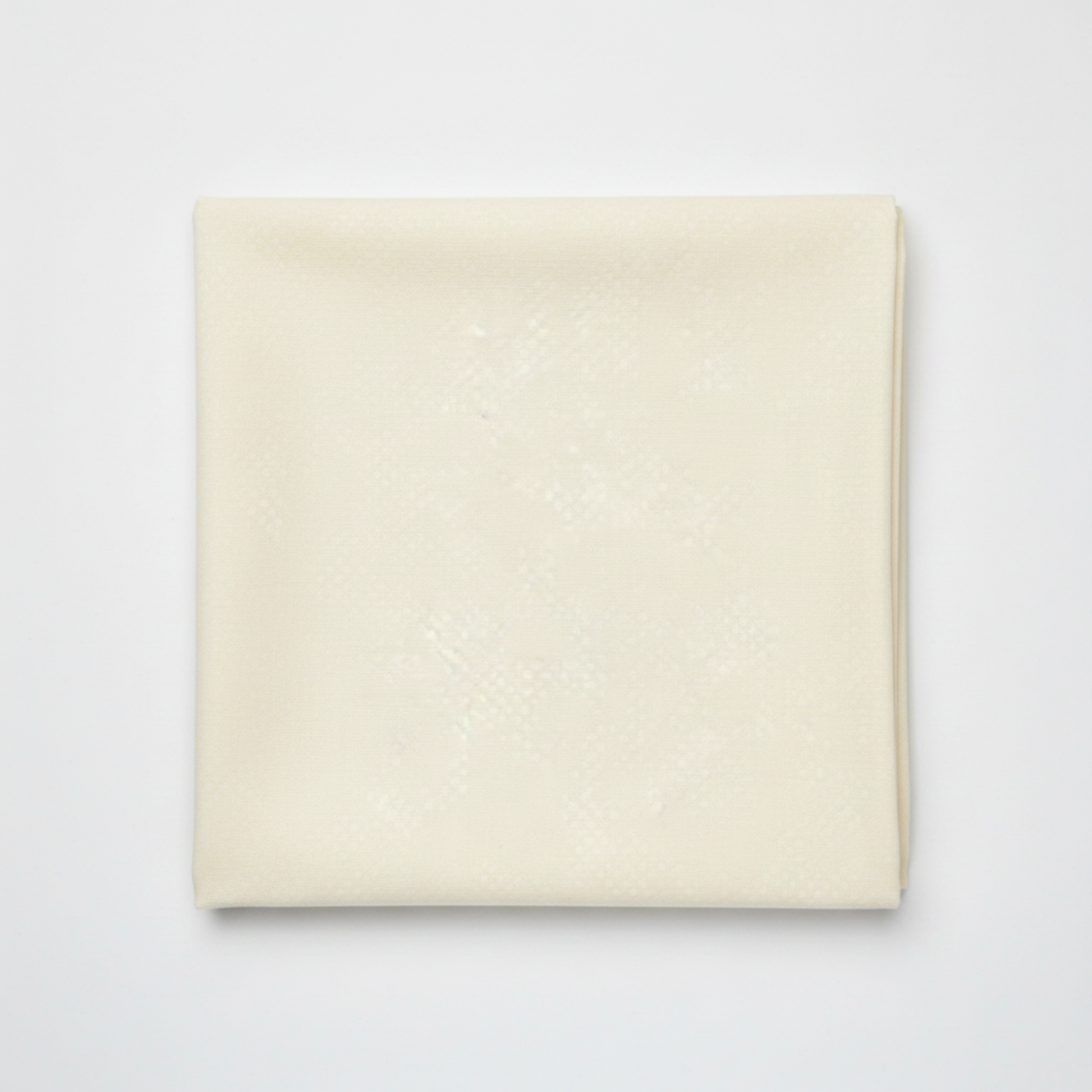 Spotted Ivory quilting cotton fabric folded to show texture – soft warm ivory tonal speckled near-solid by Zen Chic for Moda Fabrics, 100% cotton