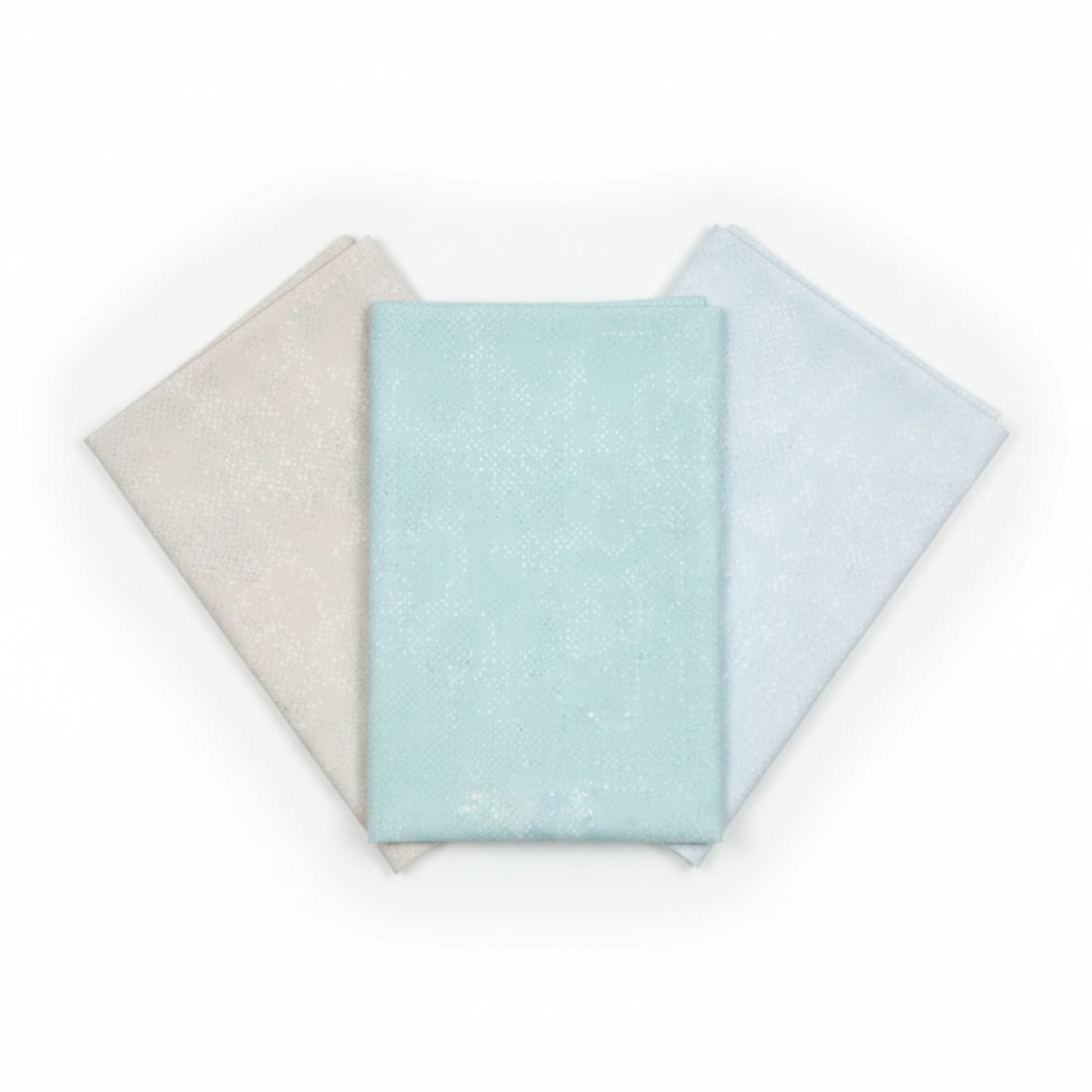 Three coordinating tonal speckled near-solid blender fabrics in a fan arrangement featuring Spotted Mist by Zen Chic for Moda Fabrics in soft pale icy aqua-blue, 100% cotton