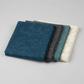 Spotted Mood Dark Blue fabric by Zen Chic for Moda Fabrics shown in a coordinating fabric fan with Spotted Chill-Aqua, Spotted Dusty Teal, Spotted Sunny, and Spotted Ivory — all available at IraRobi Quilts.