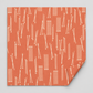 Lazy Afternoon Marmalade fabric laid flat with one corner folded back, showing its cream linear print on a coral ground.