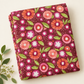Folded Superbloom Posy Party Zinnia fabric by Robin Pickens for Moda Fabrics, styled on a cream surface beside a sprig of white flowers.