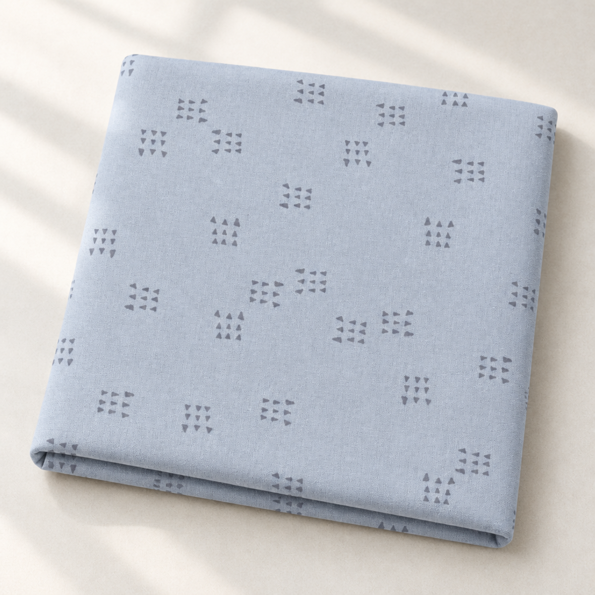 Folded Celestial Nine Triangle Stardust fabric by Zen Chic for Moda Fabrics in soft natural light.