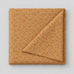 Lazy Afternoon Bronze fabric folded with one corner turned back, showing the pale dotted print on a warm bronze ground.