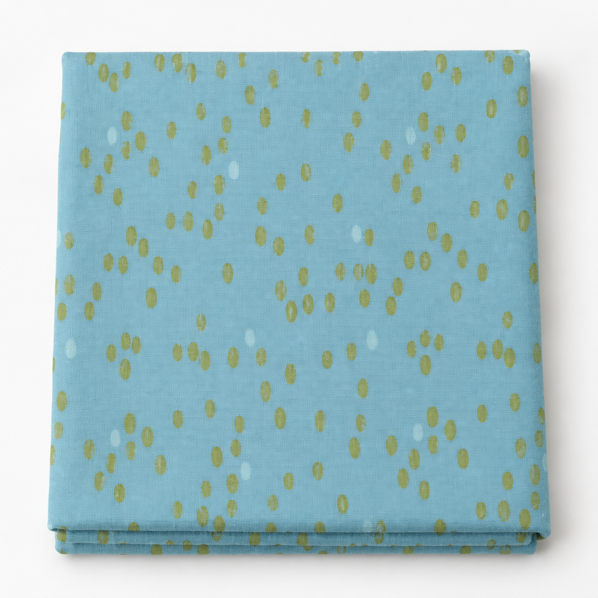 Olive You Dots Glacier Fabric by Zen Chic for Moda Fabrics, neatly folded on a white background with green and pale oval dots on blue.