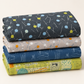 Folded stack of coordinating modern quilting fabrics in charcoal, gray, blue, and chartreuse, topped with Bluish Pins & Buttons Charcoal.