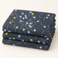 Neatly folded Bluish Pins & Buttons Charcoal quilting cotton by Zen Chic, featuring pale blue and chartreuse button-head pins.