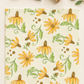 Superbloom Daisyish Cream Fabric by Robin Pickens for Moda Fabrics, laid flat on a cream background beside silver scissors, cream thread, and greenery.