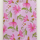 Superbloom Daisyish Freesia fabric by Robin Pickens for Moda Fabrics, neatly folded on a light surface with pink flowers, golden-brown centers, and green leaves on lavender-pink cotton.