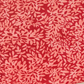 Close-up of Superbloom Leafy Geranium fabric by Robin Pickens for Moda Fabrics, showing dense coral-pink leafy branches on rich red cotton with a gently curved lower edge against a light surface.