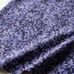 Superbloom Leafy Indigo fabric by Robin Pickens for Moda Fabrics, softly draped in loose folds on a light tabletop, showing lavender-purple leafy branches on dark indigo cotton.