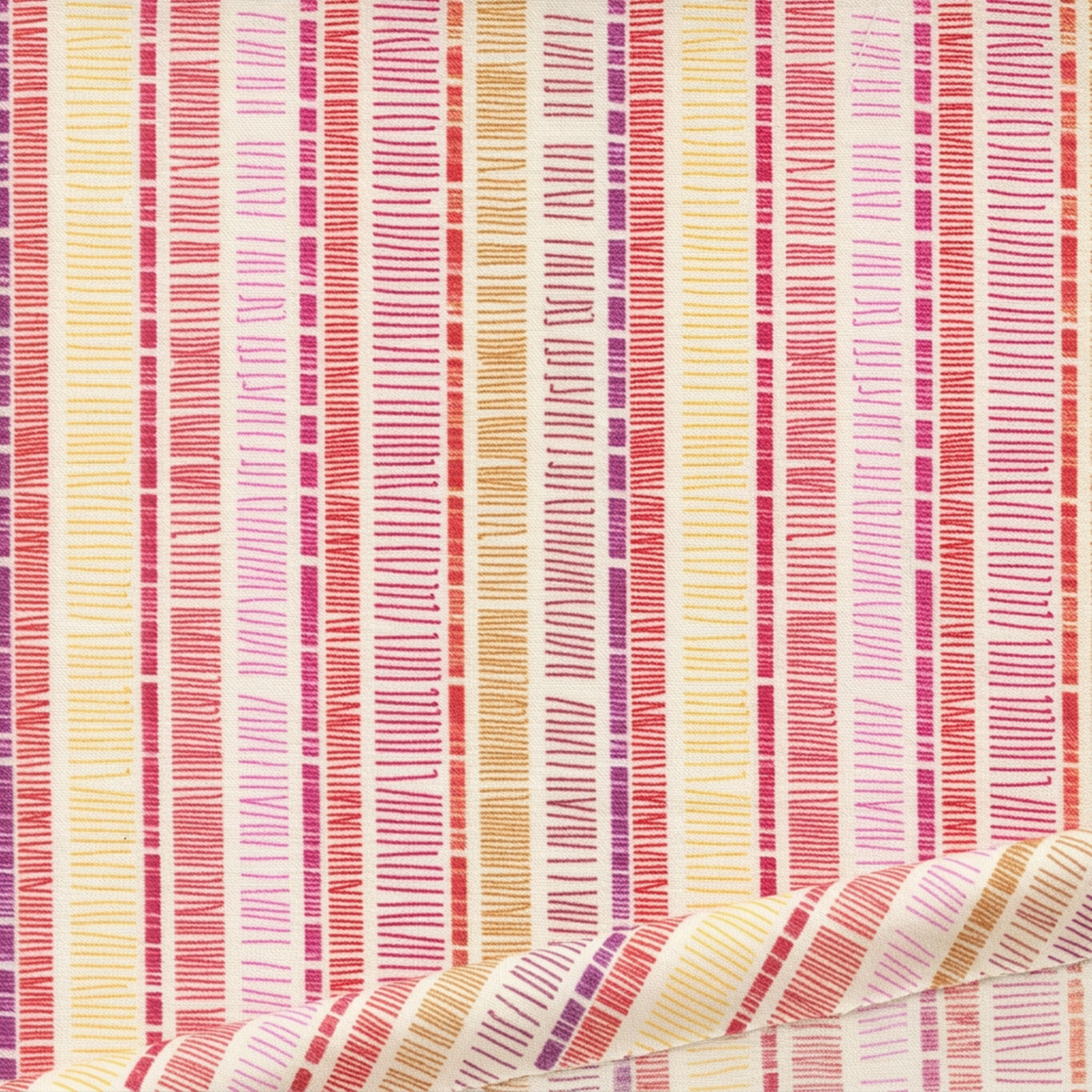 Close-up of Superbloom Scribble Stripe Cream fabric by Robin Pickens for Moda Fabrics, with colorful scribble stripes on cream cotton and a soft diagonal fold along the lower edge.
