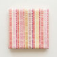 Folded Superbloom Scribble Stripe Cream fabric by Robin Pickens for Moda Fabrics on a light surface, showing colorful hand-drawn stripe bands on cream cotton.