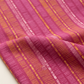 Close-up of Superbloom Scribble Stripe Orchid fabric by Robin Pickens for Moda Fabrics, showing golden-orange and pink scribble stripes across softly folded orchid-magenta cotton.