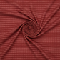 Golden Era Plaid Dot Red quilting cotton by Paula Barnes for Marcus Fabrics — fabric swirled into a spiral pinwheel showing softness and drape, deep crimson-red ground with tonal plaid grid and rose-pink dot clusters