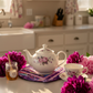 Leaf-Shaped Quilted Hot Pad – Violet Bloom under a white floral teapot with purple peonies | IraRobi Quilts #quiltedhome #cottagekitchen #handmadegift