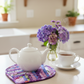 Leaf-Shaped Quilted Hot Pad – Purple Garden under a white teapot with purple flowers | IraRobi Quilts #quiltedhome #cottagekitchen #handmadegift