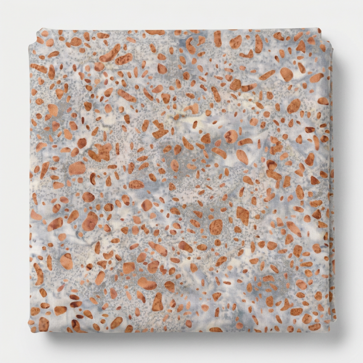Terrazzo Coastal Path Fabric by Riley Blake Designs neatly folded on a light-gray background, showing its peach and copper terrazzo-style print.