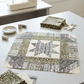 Unfinished striped star quilt block with a Khaki pebble-print frame beside folded fabric, remnants, pins, thread, and a sewing machine. Quilt blocks shown for inspiration. Coordinating fabrics and quilt patterns are available at IraRobi Quilts.