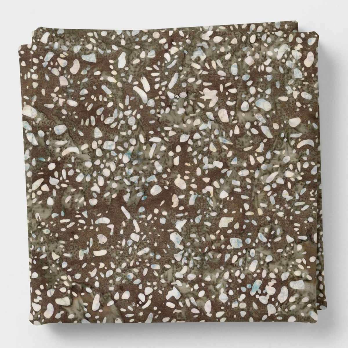 Terrazzo Khaki Fabric by Riley Blake Designs neatly folded on a light-gray background, showing its mottled earthy tones and pale pebble-shaped print.