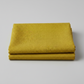 hatched Green Cury fabric by Robin Pickens for Moda Fabrics neatly folded showing the golden olive-curry tonal crosshatch texture. Pinterest: Folded Thatched Green Cury quilting cotton by Robin Pickens for Moda Fabrics on a light grey background.