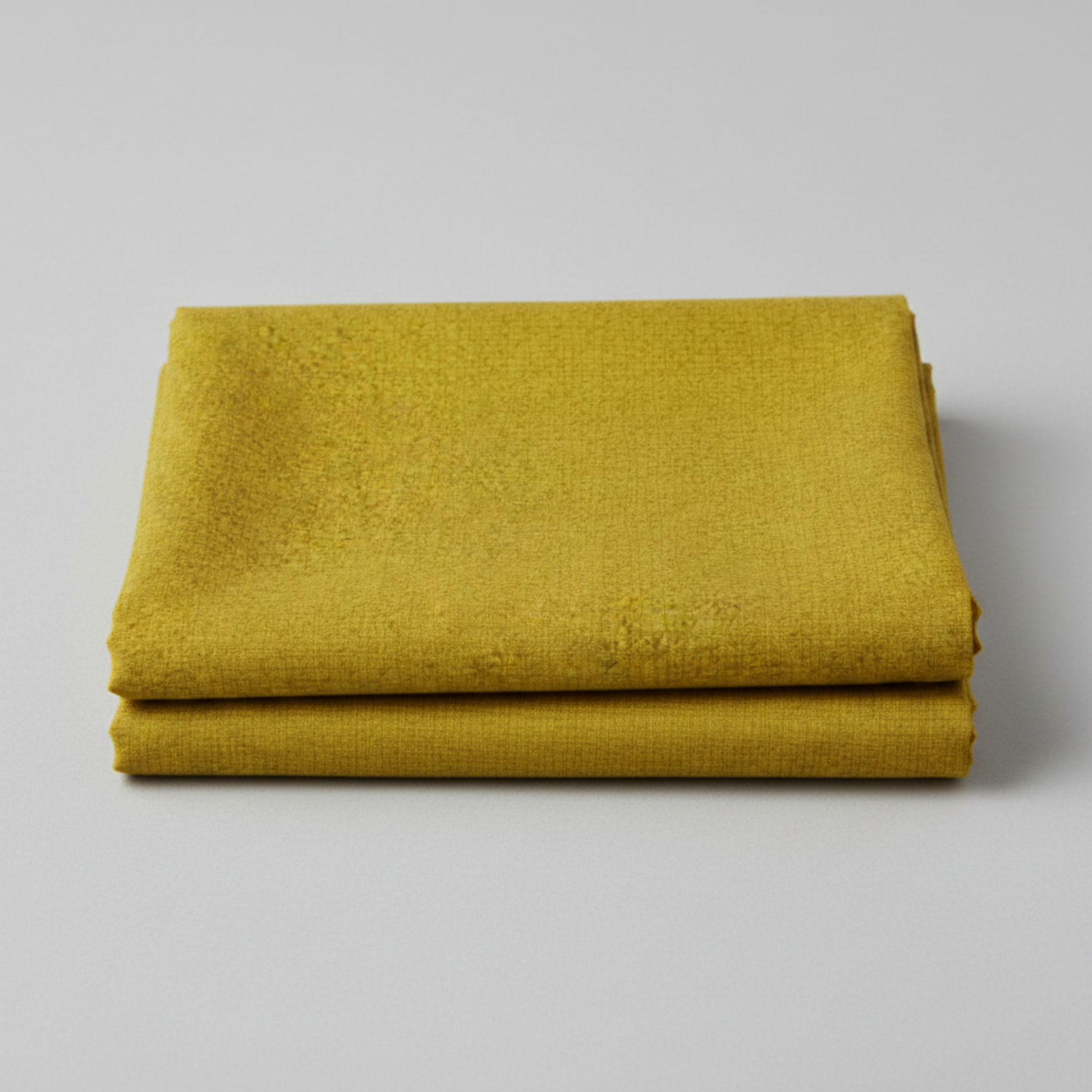 hatched Green Cury fabric by Robin Pickens for Moda Fabrics neatly folded showing the golden olive-curry tonal crosshatch texture. Pinterest: Folded Thatched Green Cury quilting cotton by Robin Pickens for Moda Fabrics on a light grey background.