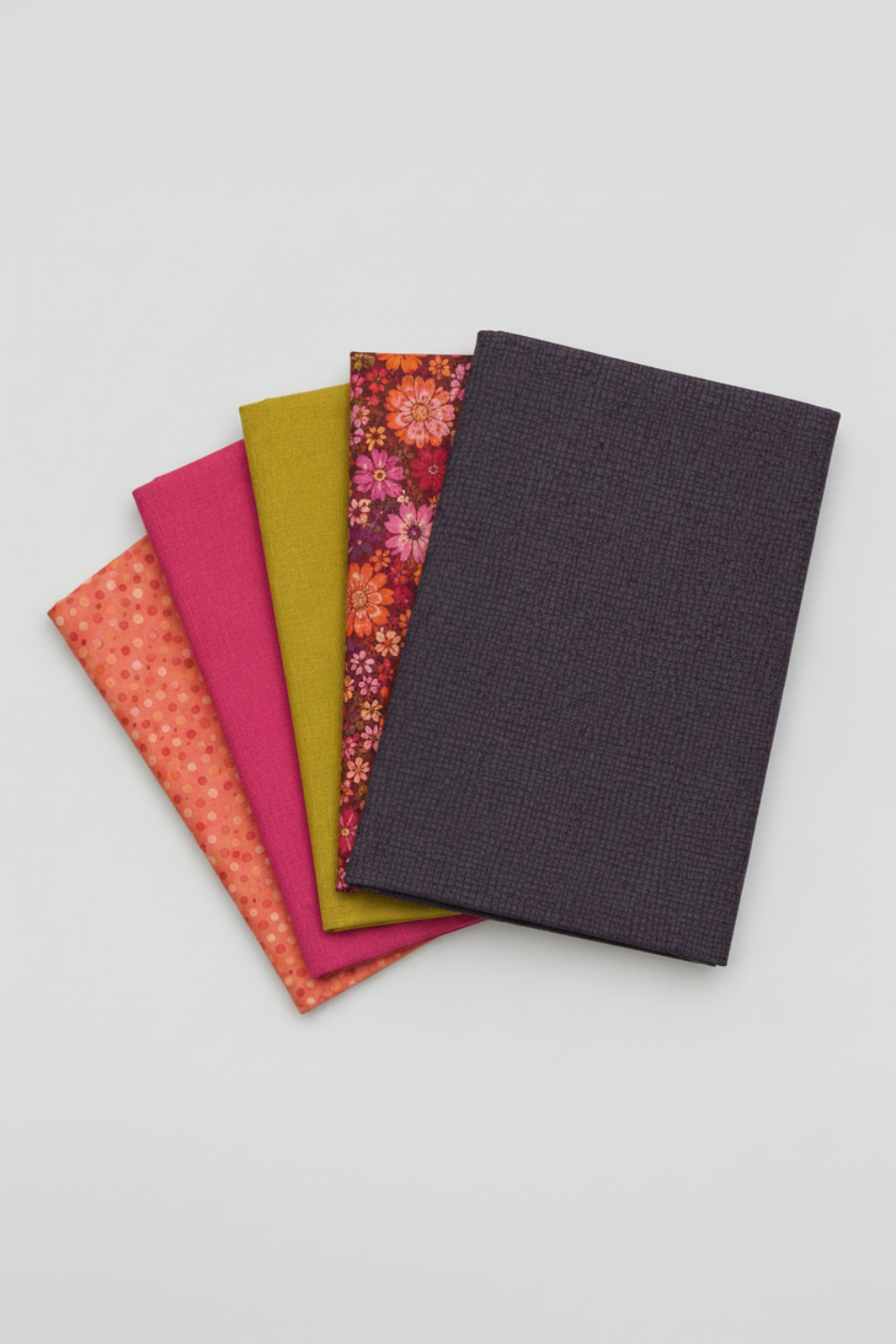 Thatched Shadow deep purple fabric by Robin Pickens for Moda Fabrics shown in a coordinating fabric fan with Thatched Fuchsia and Thatched Green Curry — all available at IraRobi Quilts.
