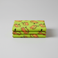 Safari Fun Tiger Too Lime by Terry Runyan for Benartex — neatly folded fabric stack showing tossed illustrated tiger print on bright lime green quilting cotton, light grey background