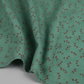 Scraps of Kindness Turquoise Heart Sprays quilting cotton in soft natural folds close-up — turquoise with crescent heart spray print, emphasizing fabric drape and texture, by Kim Diehl for Henry Glass