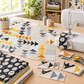 Unfinished Spotted Geese quilt featuring Celestial News Dropping Onyx fabric beside a sewing machine and quilting tools. Quilts shown for inspiration feature the Spotted Geese Quilt Pattern by Zen Chic — all available at IraRobi Quilts.
