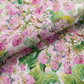 Close-up of Decoupage Pink Lilac quilting fabric draped in a soft fold, showing its layered floral pattern and textile texture.