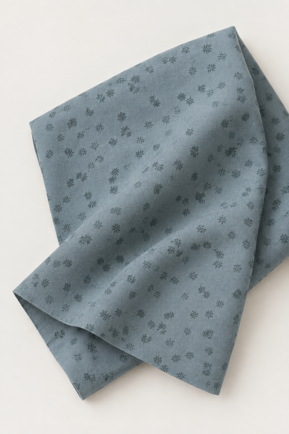 Folded Modern Background Even More Paper Steel Crosshatch fabric by Zen Chic for Moda Fabrics, showing small dark crosshatch marks on steel blue-gray fabric against a light background.