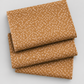 Lazy Afternoon Bronze fabric folded in three layers on a light background, showing its scattered pale dotted print.