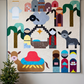 Starry Night nativity quilt hanging on a light wall beside a small illuminated Christmas tree and wrapped gifts.