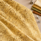 Vertical Pinterest photo of Windsong Viney Floral Fawn batik draped with coordinating cream, ochre, olive, and sienna swatches, thread, clips, and a thimble. ⠋