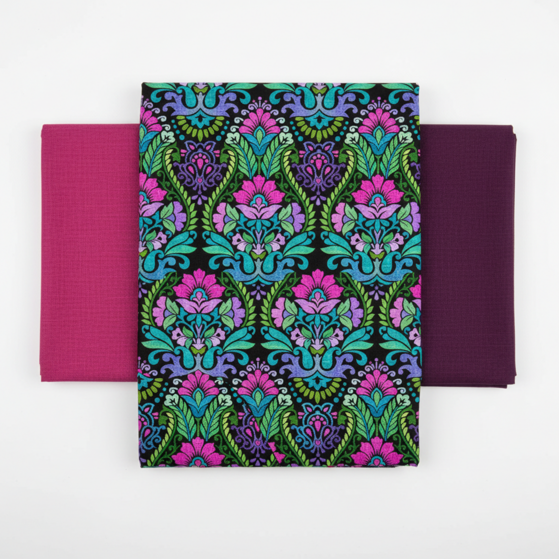 Vivid Brocade Jewel quilting cotton fabric by Jason Yenter for In The Beginning Fabrics shown in a coordinate fan with Interwoven Magenta and Interwoven Plum blenders – dramatic allover baroque brocade with magenta and purple damask florals and teal scrolling leaves on deep black, 100% cotton, 3 yard cut