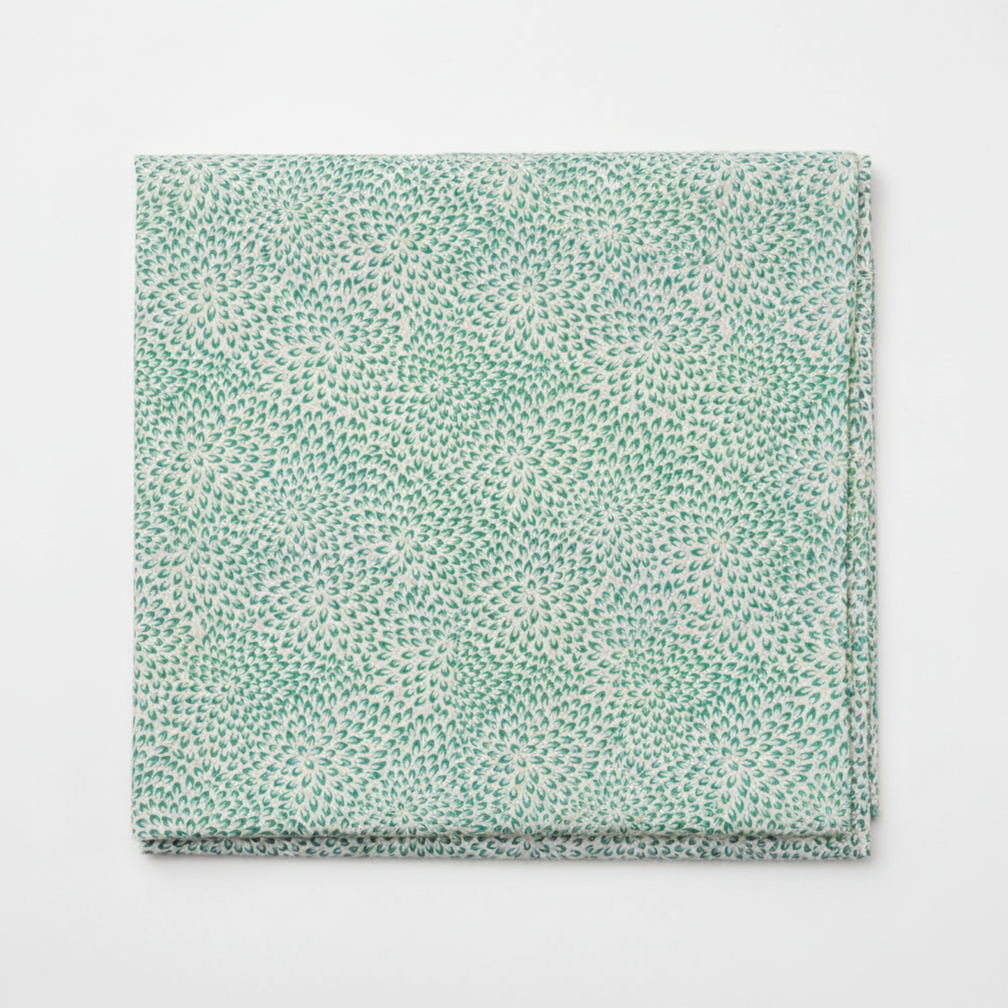 Vivid Mums Teal quilting cotton fabric folded to show dense allover chrysanthemum burst blender with hundreds of tiny pointed petals radiating in spiraling formations in teal, emerald green, sage, blue-grey, and periwinkle on light cream and silver-grey by Jason Yenter for In The Beginning Fabrics, 100% cotton, 3 yard cut