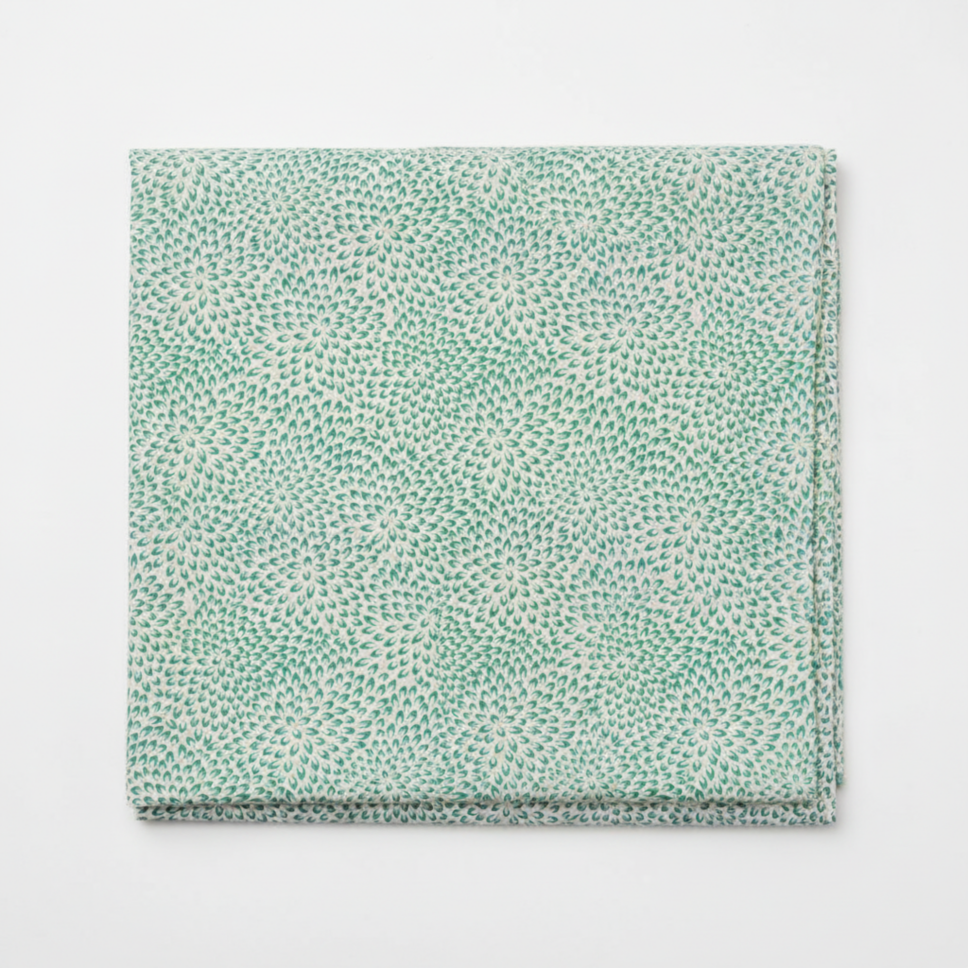Vivid Mums Teal quilting cotton fabric folded to show dense allover chrysanthemum burst blender with hundreds of tiny pointed petals radiating in spiraling formations in teal, emerald green, sage, blue-grey, and periwinkle on light cream and silver-grey by Jason Yenter for In The Beginning Fabrics, 100% cotton, 3 yard cut