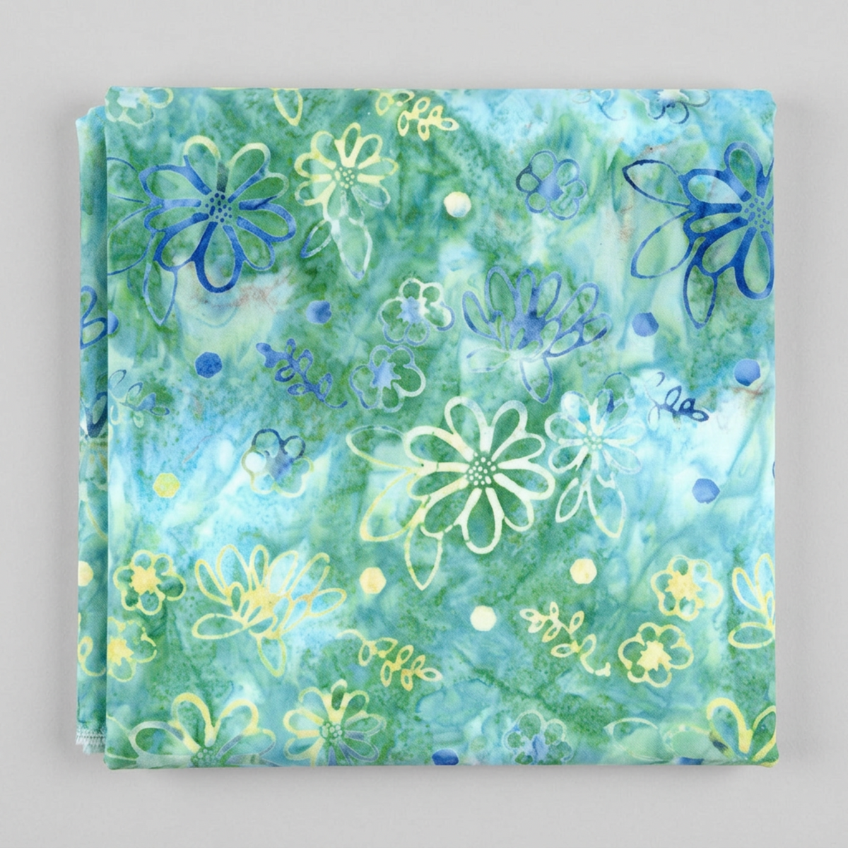 Folded Watercolor Daisies Caribbean Shale batik fabric by Beverly McCullough for Riley Blake Designs, showing blue and pale yellow daisies on an aqua-green ground against a light gray background.