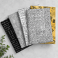 Writing on the Wall Well Worded White fabric on top of coordinating FreeSpirit fabrics stack — black script, white word print, and golden yellow prints