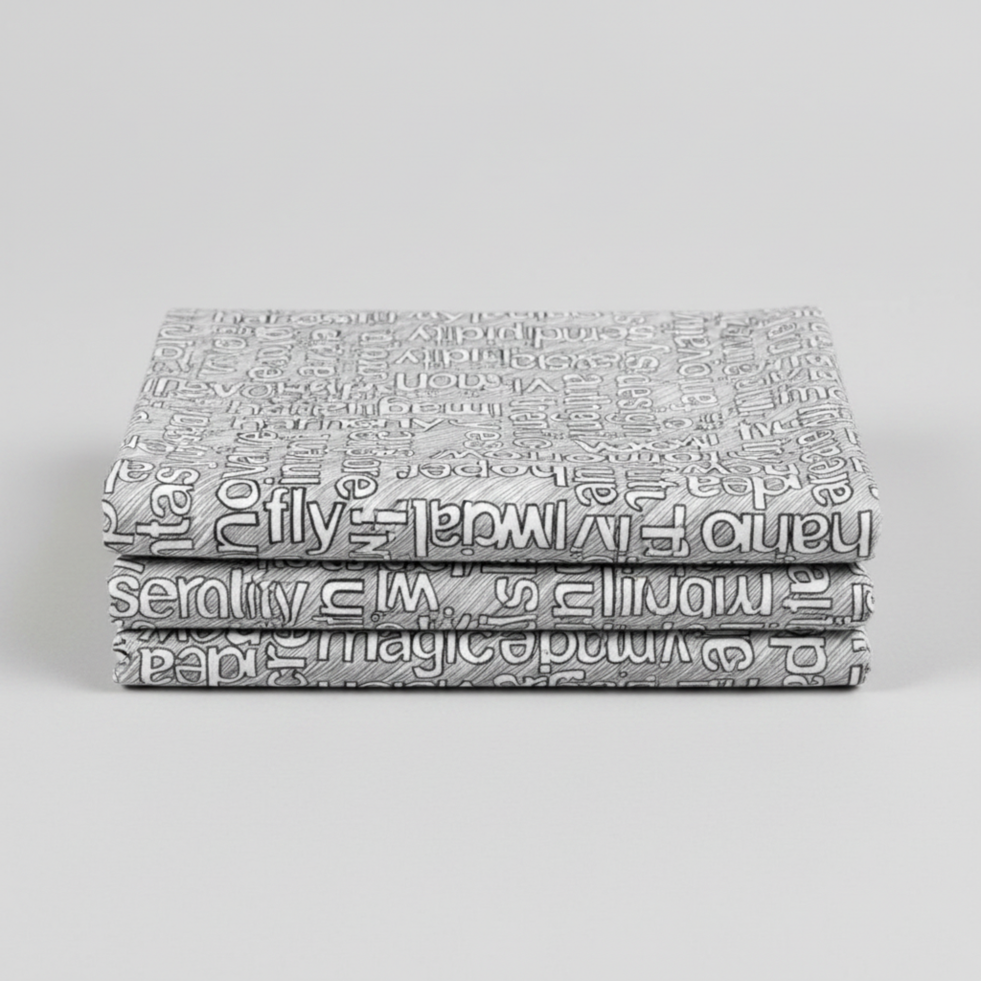 Writing on the Wall Well Worded White quilting cotton in soft fold stack — grey background with white and black word art typography, FreeSpirit Fabrics
