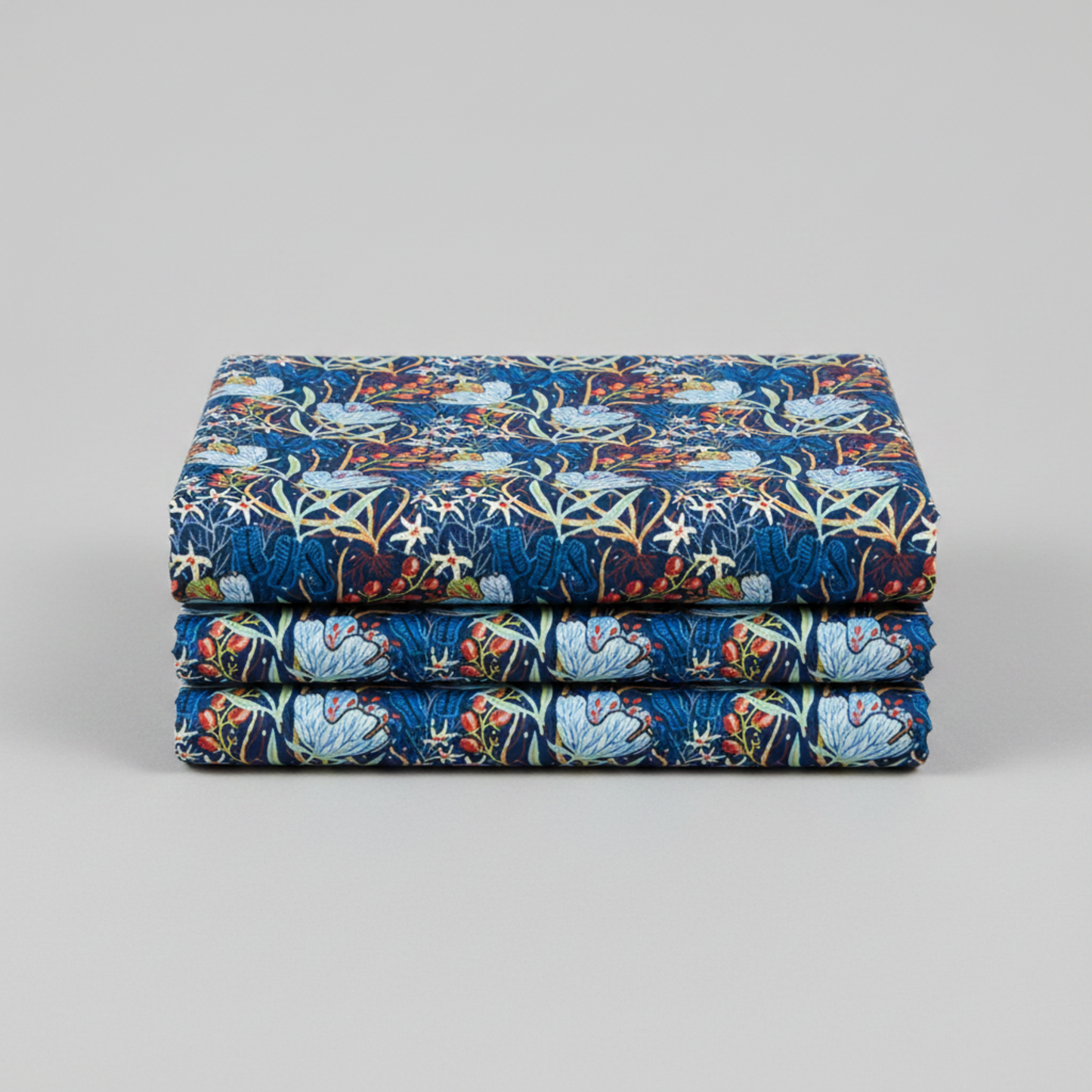 Whimsy Anemones and Berry Pods Blue 3 Yard Cut quilting cotton by Jason Yenter for In The Beginning Fabrics — three yards neatly folded and stacked showing large powder blue anemone blooms, red-orange berry pod clusters, white star flowers, and sage green leaves on rich navy ground. Coordinating fabrics and quilt patterns are available at IraRobi Quilts.