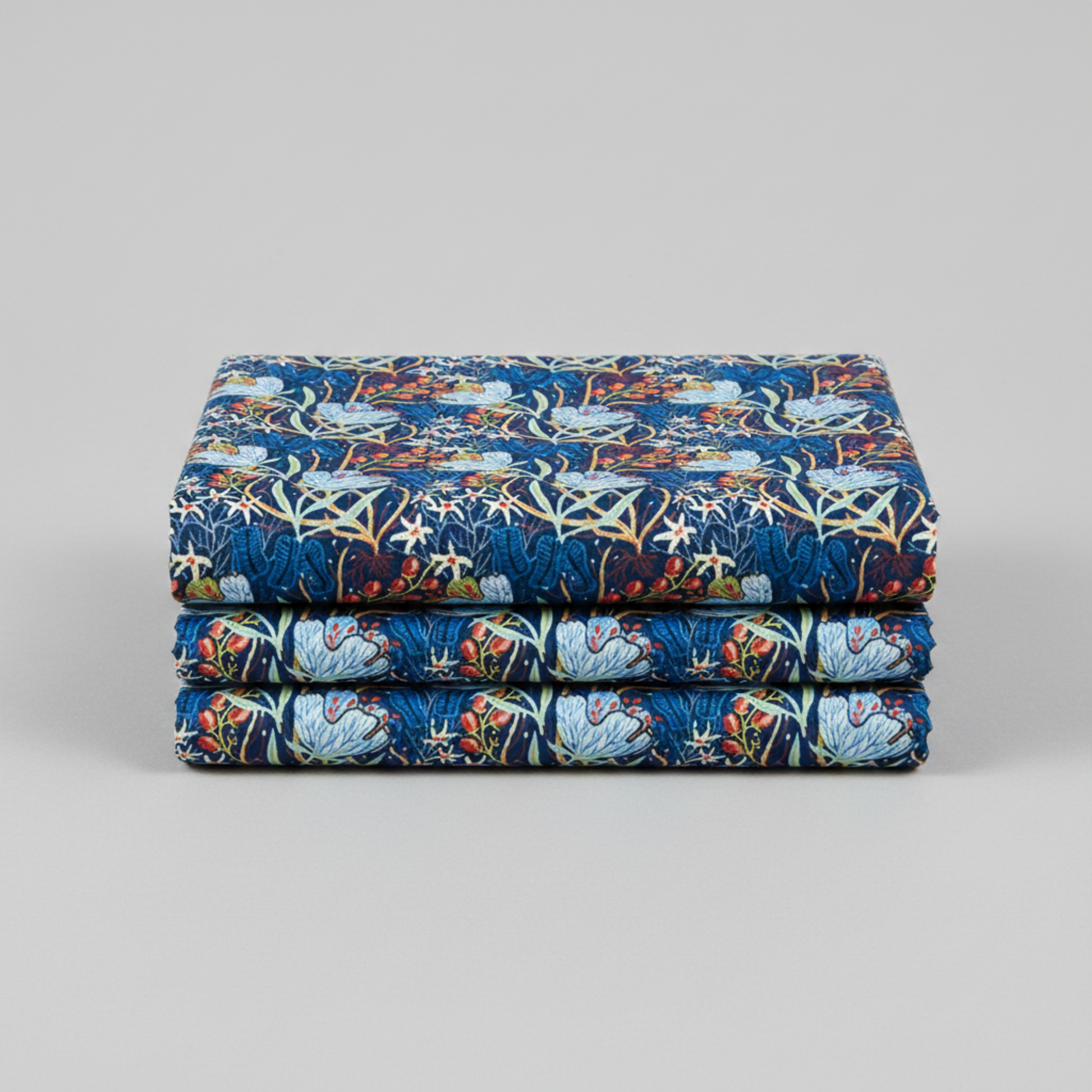 Whimsy Anemones and Berry Pods Blue 3 Yard Cut quilting cotton by Jason Yenter for In The Beginning Fabrics — three yards neatly folded and stacked showing large powder blue anemone blooms, red-orange berry pod clusters, white star flowers, and sage green leaves on rich navy ground. Coordinating fabrics and quilt patterns are available at IraRobi Quilts.