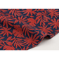 Close-up of Breezeway Red/Blue Textured Palms fabric draped to show its red tropical foliage print, deep blue ground, and woven cotton texture.