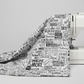 Writing on the Wall Word Collage White fabric draped over white sewing machine edge — black and white word collage quilting cotton by FreeSpirit Fabrics